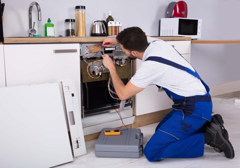 workman fixing a dishwasher